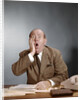 1960s Shocked Balding Executive With Hand To Cheek Sitting At Desk by Anonymous