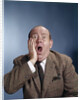 1960s Balding Businessman Holding Hand Up To Face Shocked Expression Eyes Bulging Mouth Open by Anonymous