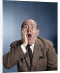 1960s Balding Businessman Holding Hand Up To Face Shocked Expression Eyes Bulging Mouth Open by Anonymous