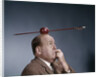 1960s Anxious Business Man Biting Finger With Nails Arrow Shot Through Apple On Of His Top Head by Anonymous