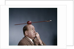 1960s Anxious Business Man Biting Finger With Nails Arrow Shot Through Apple On Of His Top Head by Anonymous