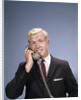 1960s Young Businessman Salesman Talking On Telephone by Anonymous