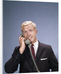 1960s Young Businessman Salesman Talking On Telephone by Anonymous
