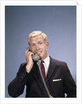 1960s Young Businessman Salesman Talking On Telephone by Anonymous