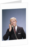 1960s Young Businessman Salesman Talking On Telephone by Anonymous