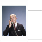 1960s Young Businessman Salesman Talking On Telephone by Anonymous