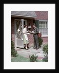 1950s Mailman Delivering Mail To Woman Brick Suburban Home by Anonymous