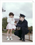 1960s Man Police Officer Comforting Crying Scared Little Lost Girl In Suburban Neighborhood by Anonymous