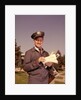 1960s Mailman Holding Letters Mail Leather Mailbag In Suburban Neighborhood by Anonymous