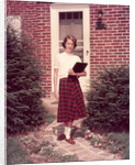 1950s Teenage Girl Holding School Books Walking Down Flagstone Walk by Anonymous