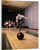 1960s Man In Good Form Releasing Bowling Ball Down Lane Wife Woman 2 Kids Behind Him by Anonymous