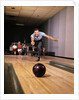 1960s Man In Good Form Releasing Bowling Ball Down Lane Wife Woman 2 Kids Behind Him by Anonymous