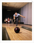 1960s Man In Good Form Releasing Bowling Ball Down Lane Wife Woman 2 Kids Behind Him by Anonymous