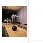 1960s Man In Good Form Releasing Bowling Ball Down Lane Wife Woman 2 Kids Behind Him by Anonymous