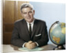 1960s Portrait Man Businessman Sitting At Desk Next To Globe Of The Earth by Anonymous