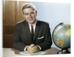 1960s Portrait Man Businessman Sitting At Desk Next To Globe Of The Earth by Anonymous