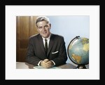 1960s Portrait Man Businessman Sitting At Desk Next To Globe Of The Earth by Anonymous