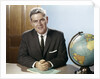 1960s Portrait Man Businessman Sitting At Desk Next To Globe Of The Earth by Anonymous