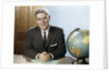 1960s Portrait Man Businessman Sitting At Desk Next To Globe Of The Earth by Anonymous