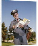 1960s Mailman Holding Letters Mail Leather Mailbag In Suburban Neighborhood by Anonymous