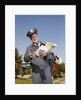 1960s Mailman Holding Letters Mail Leather Mailbag In Suburban Neighborhood by Anonymous