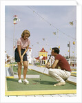 1950s 1960s Young Couple Man Woman Play Miniature Golf Summer Amusement by Anonymous