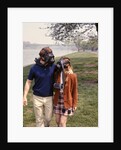1970s Young Romantic Teenage Couple Man Woman Wearing Gas Masks Walking By River by Anonymous
