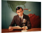 1960s Reporter Reading News Into Microphone With Global Map In Background by Anonymous