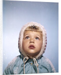1960s Cold Little Girl In Winter Coat And Hood Looking Up At Falling Snow by Anonymous