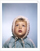 1960s Cold Little Girl In Winter Coat And Hood Looking Up At Falling Snow by Anonymous