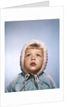 1960s Cold Little Girl In Winter Coat And Hood Looking Up At Falling Snow by Anonymous