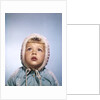 1960s Cold Little Girl In Winter Coat And Hood Looking Up At Falling Snow by Anonymous