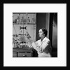 1930s 1940s Woman Scientist In Lab Coat Holding Up And Examining Beaker Of Liquid by Anonymous