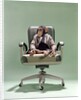 1970s Businessman Chimpanzee Sitting In Office Chair by Anonymous