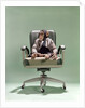 1970s Businessman Chimpanzee Sitting In Office Chair by Anonymous