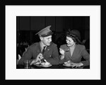 1940s Soldier In Army Uniform And Girlfriend Sitting At Soda Fountain Counter Eating Dish Of Ice Cream by Anonymous