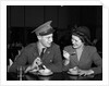 1940s Soldier In Army Uniform And Girlfriend Sitting At Soda Fountain Counter Eating Dish Of Ice Cream by Anonymous
