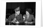 1940s Soldier In Army Uniform And Girlfriend Sitting At Soda Fountain Counter Eating Dish Of Ice Cream by Anonymous