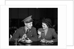 1940s Soldier In Army Uniform And Girlfriend Sitting At Soda Fountain Counter Eating Dish Of Ice Cream by Anonymous