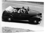 1930s 1940s Couple Driving 1938 Convertible Four Door Sedan Automobile With Luggage In Back Seat by Anonymous