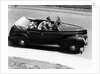 1930s 1940s Couple Driving 1938 Convertible Four Door Sedan Automobile With Luggage In Back Seat by Anonymous