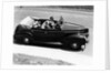 1930s 1940s Couple Driving 1938 Convertible Four Door Sedan Automobile With Luggage In Back Seat by Anonymous