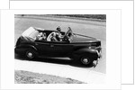 1930s 1940s Couple Driving 1938 Convertible Four Door Sedan Automobile With Luggage In Back Seat by Anonymous