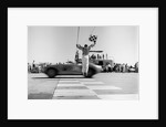 1960s Man Jumping Waving Checkered Flag As Winning Sports Car Crossing The Finish Line by Anonymous