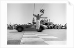 1960s Man Jumping Waving Checkered Flag As Winning Sports Car Crossing The Finish Line by Anonymous