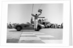 1960s Man Jumping Waving Checkered Flag As Winning Sports Car Crossing The Finish Line by Anonymous
