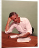 1970s Middle Age Man Sitting At Desk Worried About Bills To Pay by Anonymous