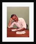 1970s Middle Age Man Sitting At Desk Worried About Bills To Pay by Anonymous