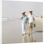 1970s Senior Couple Walking Beach Holding Hands Wearing Straw Hats by Anonymous