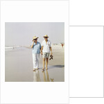1970s Senior Couple Walking Beach Holding Hands Wearing Straw Hats by Anonymous